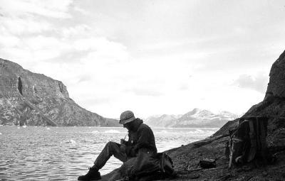 John Ferguson taking notes on an expedition in Greenland